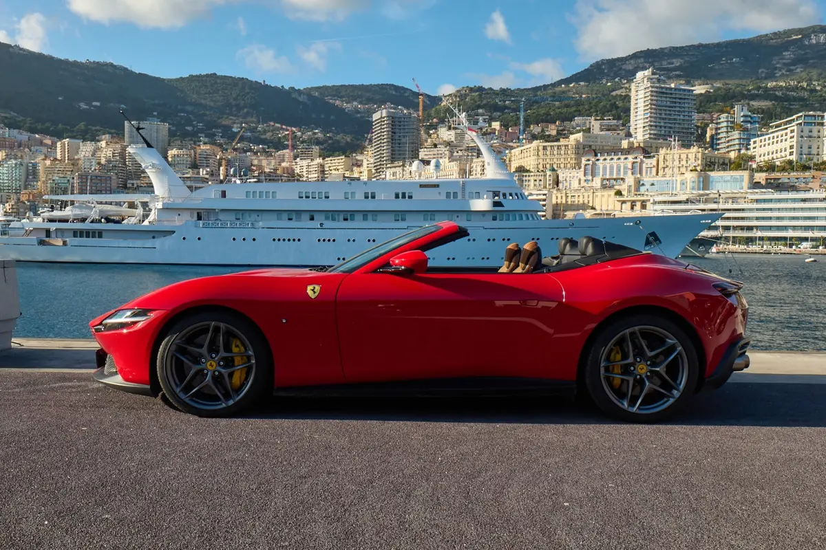 Ferrari Roma Spider 2024, exterior — Marbella Luxury Car Rental, Marbella. The Ferrari Roma Spider pairs a front-mounted V8 producing 620 hp with a folding soft-top…