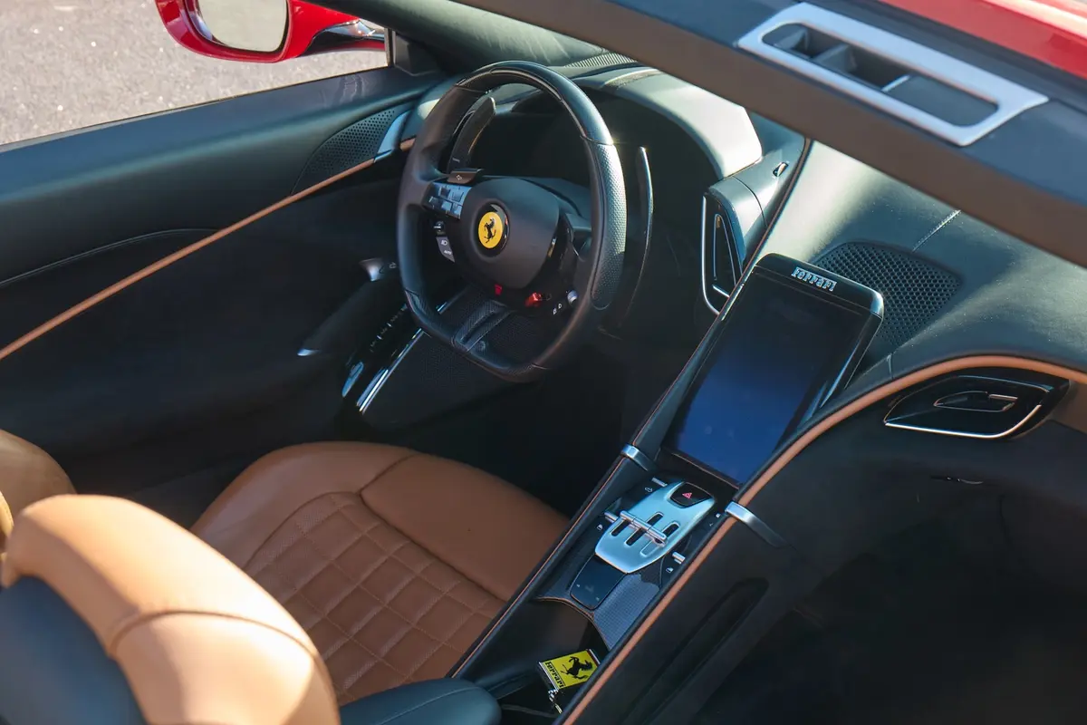 Ferrari Roma Spider 2024, rear view — Marbella Luxury Car Rental, Marbella. The Ferrari Roma Spider pairs a front-mounted V8 producing 620 hp with a folding soft-top…